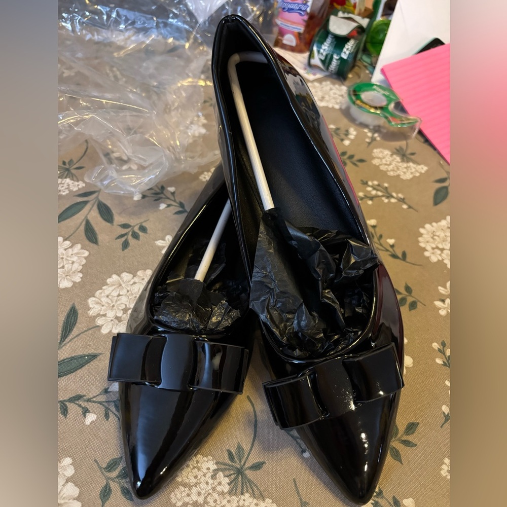 Black Patent Flat with Bow. Size 10
Medium. New.